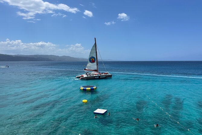 Half Day Catamaran Party Boat, Snorkeling and Hip Strip Tour - Sunbathing from the front nets